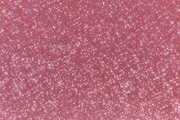Abstract pink background with sparkles in the shape of stars. Festive backdrop for your projects. Blurry sparkling background.