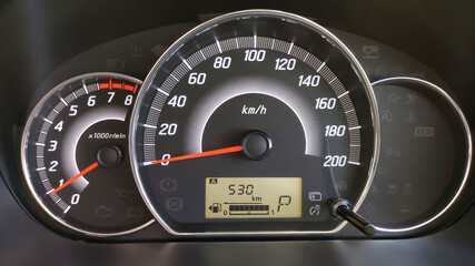 Close-up of the engine, the car's speedometer and the amount of fuel. Cheap oil concept. Hurry to...