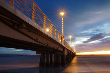 pier over the sea after the sunset in marina di massa - obrazy, fototapety, plakaty