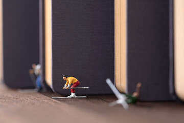 A skier whose miniature ideas slide out of a book