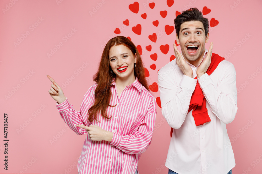 Sticker Young shocked couple two friends woman man 20s wear casual shirt point index finger aside on copy space area hold face isolated on plain pink background Valentine's Day birthday holiday party concept