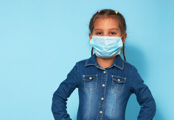 Little girl wearing face mask over blue background
