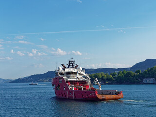 The Skandi Iceman, a Norwegian Registered Offshore Supply Vessel and Tug departing Bergen Harbour on a clear day in June