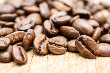 Coffee beans on wooden background.