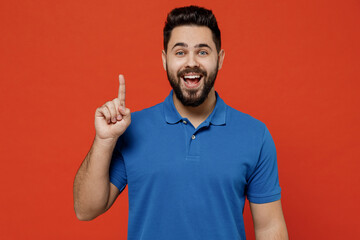 Young smiling happy insighted smart proactive man 20s wear basic blue t-shirt holding index finger...