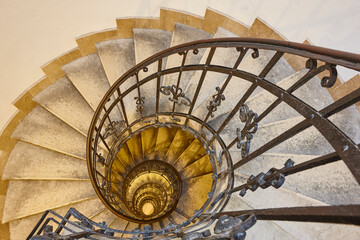 Spiral staircase made with stone and iron handrail. Classic building