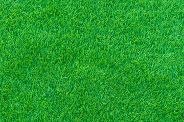 The green grass in the park is taken from above, or it can be artificial grass in the sports field...