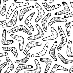 A pattern of boomerangs of different shapes and with different patterns on a white background. Traditional souvenir and Australian native symbols. Hand-drawn. Vector illustration.