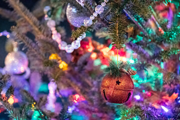 Obraz na płótnie Canvas Red glitter jingle bell on Christmas tree