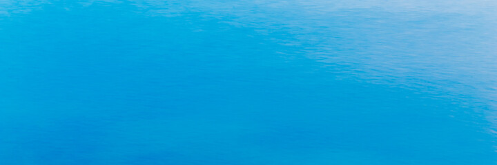 A wide picture of a bright turquoise sea background or as a pool water background can be used as a background image, suitable for use in marine or cartoon aquatic projects.