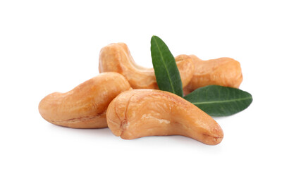 Pile of tasty organic cashew nuts and green leaves isolated on white