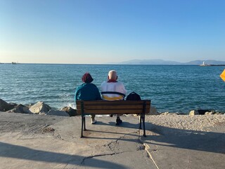 Naklejka na ściany i meble senior couple sitting on a bench