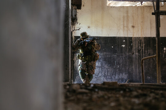 Airsoft solder on battlefield. Airsoft soldier with a rifle.