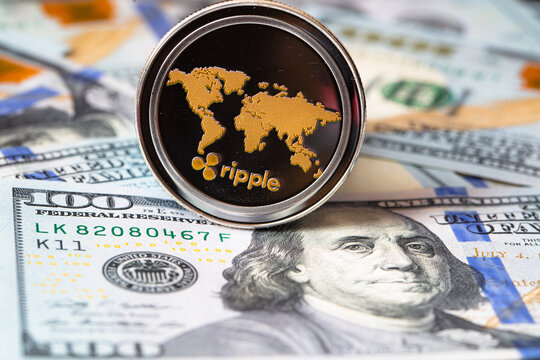 Ripple coin, XRP token, cryptocurrency on US 100 dollar background