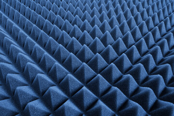 Studio sound proof foam pattern texture. Blue triangular acoustic foam rubber. Shallow depth of...