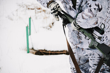 Sniper's hands in winter re-strap the bipod