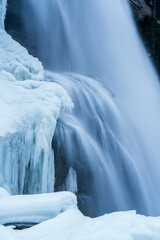 arctic landscape of frozen water from a waterfall in long exposure photography in the mountains