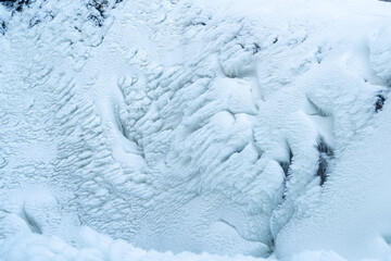 winter landscape with ice formation at a frozen waterfall