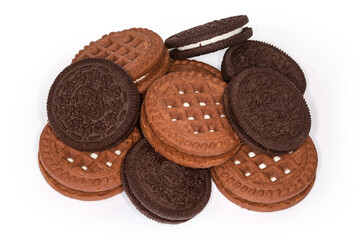 Different dark round sandwich cookies on a white background