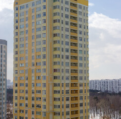 Fototapeta premium Fragment of multi story apartment building facade against the sky