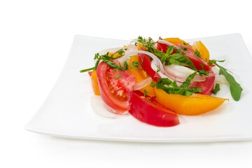 Tomato salad on square dish on white background, close-up