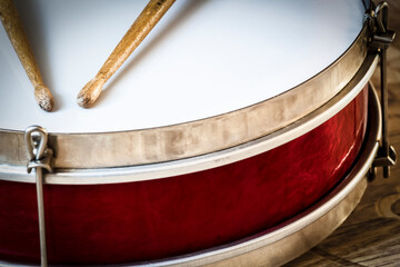 Pioneer red snare drum and wooden drumsticks.