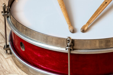 Fototapeta na wymiar Pioneer red snare drum and wooden drumsticks.