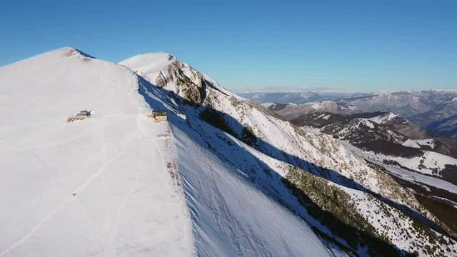 A man riding skis down a snow covered mountain