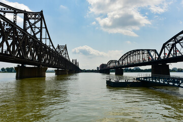 At the broken bridge site of Yalu River in Dandong, China, the Chinese on the plaque is translated into English: 