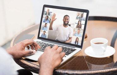 Unrecognizable Black Freelancer Guy Working In Cafe, Videoconferencing On Laptop