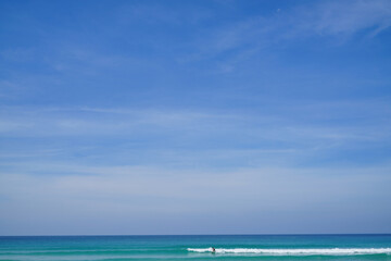 Fototapeta na wymiar Surfer, Kata Noi Beach, Andaman Sea with blue sky Phuket, Thailand including copy space