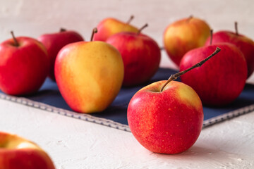 Many red fresh apples on a white background.