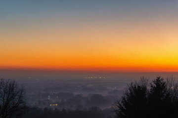 Fototapeta premium Conjunction of the Planets Venus and Jupiter at sunset over foggy landscape, Munsterland, Germany