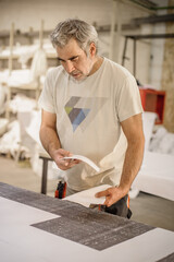 Logistic printing technician worker controls and arranges the printed material