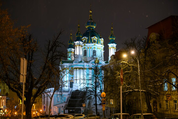 Evening snowy view of St. Andrew Church from Desyatynna Street in Kyiv, Ukraine. December 2021