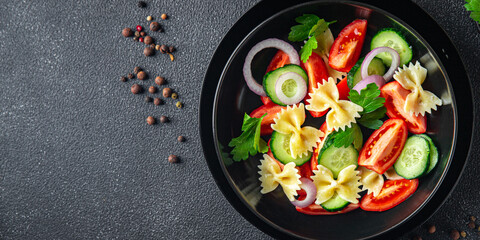 pasta salad no meat tomato, cucumber, farfalle, healthy meal diet snack on the table copy space food background rustic