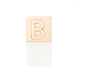 Wooden cubes with letters B on a white background