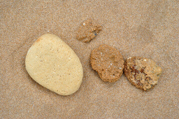 Close Up of Small Stones on Sandy Beach