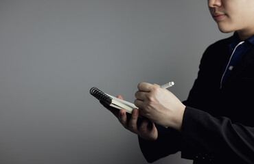 man holding pencil taking short notes into notebook. concept of task planning, creativity,...