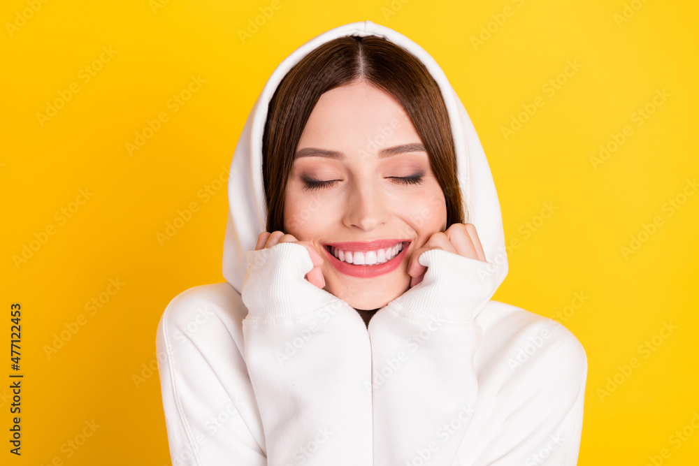 Wall mural Portrait of attractive dreamy cheerful girl wearing cozy garment enjoying warmth isolated over bright yellow color background - Wall murals
