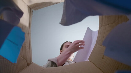 Photo of woman throwing teared paper, bottom view