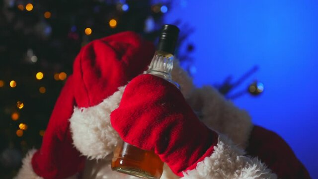 Santa with bottle of whiskey after the new year.