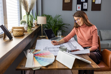 Female architect working on project. Construction Industry, Working, Drawing - Activity, Industry. Female designer in office working on architects project. 