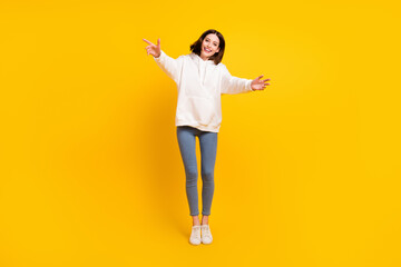 Fototapeta na wymiar Full length body size view of attractive cheerful girl jumping hugging you having fun isolated over bright yellow color background