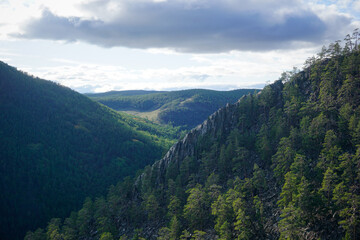 Fototapeta na wymiar Rocky mountains in the forest of Olkhon island