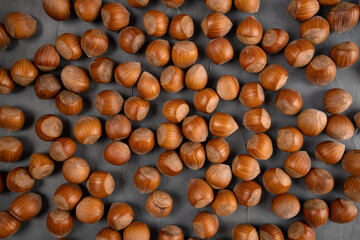Peeled hazelnuts pattern, top view. Bio nuts on grau background.