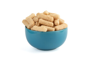 Sweet buckwheat sticks in a blue bowl over a white background.