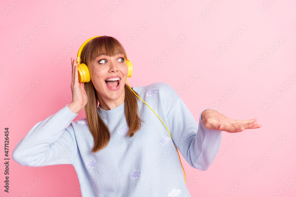 Poster Portrait of pretty cheerful girl listening melody having fun dancing moving rhythm isolated over pink pastel color background