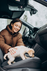 Woman with her cute dog sitting in car