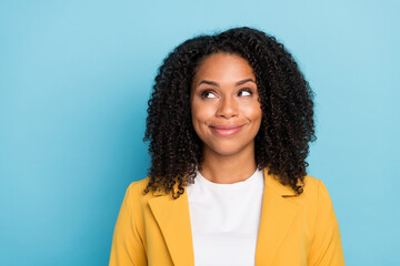 Fototapeta na wymiar Photo of young black woman happy positive smile dream curious think look empty space isolated over blue color background